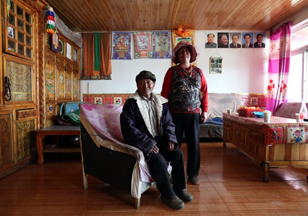 Pedor and his wife in their house in a relocation village built for former herdmen. (WANG JING/CHINA DAILY)