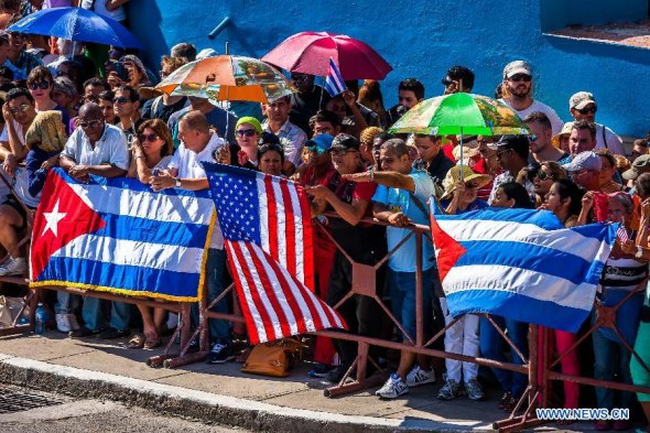 People watch flag-raising ceremony at the U.S. embassy in Havana, Cuba, Aug. 14, 2015. U.S. Secretary of State John Kerry chaired here on Friday the formal ceremony of raising the American flag in the recently reopened U.S. embassy in Cuba, after 54 years of animosity between the two neighbors. (Photo: Xinhua/Liu Bin)