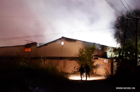 Smoke rises from the blasted warehouse in Tianjin, China, Oct. 13, 2015. A blast hit a warehouse for alcohol materials in north China's Tianjin Municipality on Monday night, with no casualties reported so far, local authorities said. (Photo: Xinhua/Zhang Chenlin)