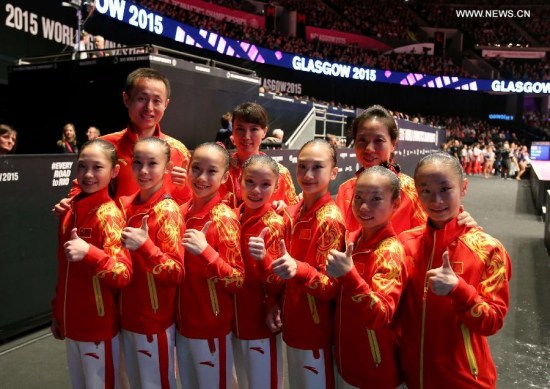 Chinese gymnasts pose with their coaches after the women's team final at the 46th World Artistic Gymnastics Championships at the SSE Hydro Arena in Glasgow, Scotland, Great Britain on Oct. 27, 2015. China won the silver medals. (Photo: Xinhua/Han Yan)