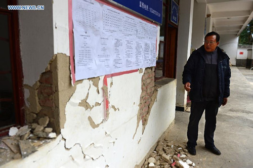 Wang Shaojun, a headmaster of a primary school, checks the campus after an earthquake hit the small town of Datianba in southwest China's Yunnan Province, Oct. 31, 2015. According to the provincial civil affairs department, 856 people were forced to evacuate, while 168 houses collapsed and over 12,000 were damaged after the 5.1-magnitude earthquake. (Xinhua/Hu Chao) 