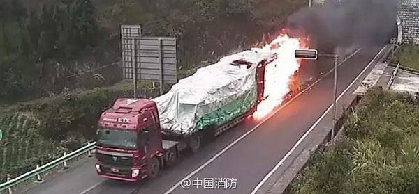 A burning truck rushes out of a tunnel in Southwest China's Guizhou province on Saturday. (Photo/weibo.com)