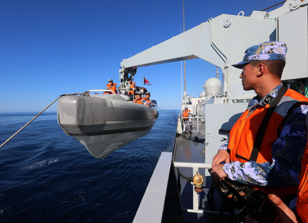 The Chinese missile destroyer Jinan prepares to rescue a small naval vessel as part of the first joint military drill to be staged between China and the U.S. in the Atlantic Ocean. The six-hour exercise took place on Saturday and each country sent three warships. (Photo/Xinhua)