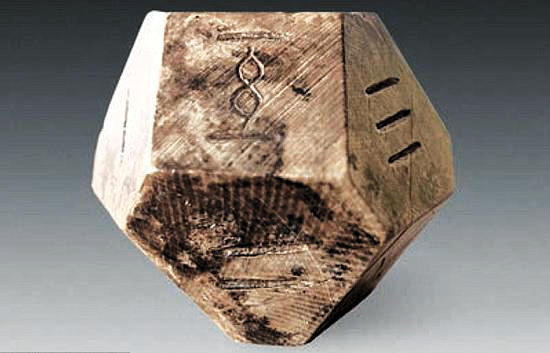 A 14-sided dice made of animal bone found in the 2300-year-old tomb in Shandong. (File Photo)