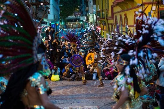 Participants perform during a carnival parade in celebration of the 16th anniversary of Macao's return to motherland and the 10th anniversary of the historical sites listed as World Heritage, in Macao, south China, Dec. 6, 2015. (Xinhua/Cheong Kam Ka)