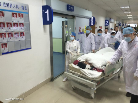 Tian Zeming, a survivor found in the landslide site, receives medical treatment at a hospital in Shenzhen, south China's Guangdong Province, Dec. 23, 2015. Tian was pulled out alive early Wednesday morning more than 60 hours after a landslide in Shenzhen. (Xinhua/Sun Fei)