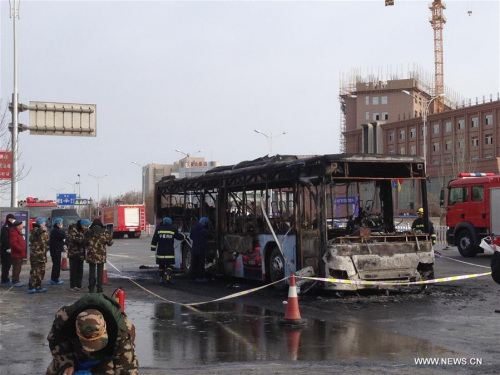 Firefighters work at the accident site of bus fire in Helan County, northwest China's Ningxia Hui Autonomous Region, Jan. 5, 2016. Fourteen people were killed and more than 30 others injured, after the bus caught fire Tuesday morning. (Photo: Xinhua/Li Ran)