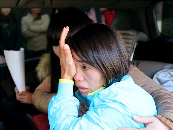 Qian Renfeng wipes away tears on Dec 21, the day her conviction was overturned by the Yunnan Provincial High People's Court. The 30-year-old was sentenced to life imprisonment 13 years ago after being wrongfully convicted of poisoning children. Photo provided to China Daily