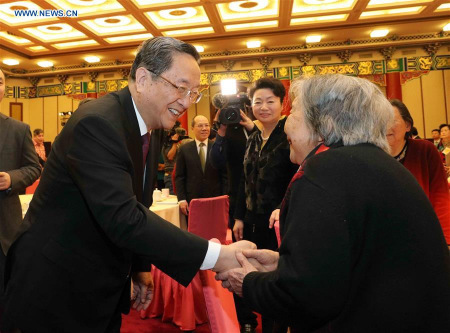 Yu Zhengsheng (L), chairman of the National Committee of Chinese People's Political Consultative Conference (CPPCC), attends a New Year gathering held by the CPPCC National Committee for spouses of late renowned social figures and national political advisors who were not members of the Communist Party of China (CPC), in Beijing, China, Jan. 26, 2016. (Xinhua/Liu Weibing)