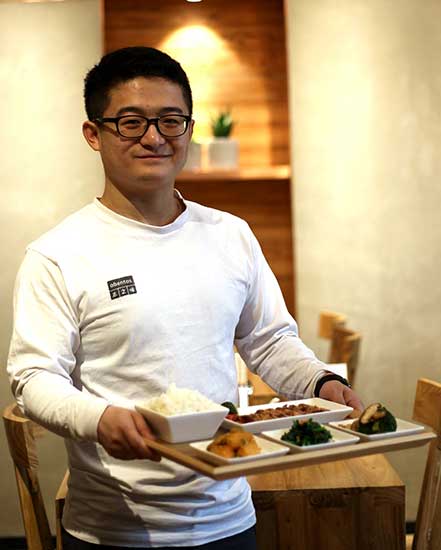 Obentos manager Justin Hao says health-minded customers choose from vegetarian and meat-centered dishes to fit their exercise plans. (Photo: China Daily/Guan Xin)