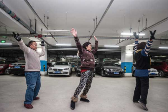 People dance in an underground garage in Beijing. Photo: China Daily/Chen Ruishi)