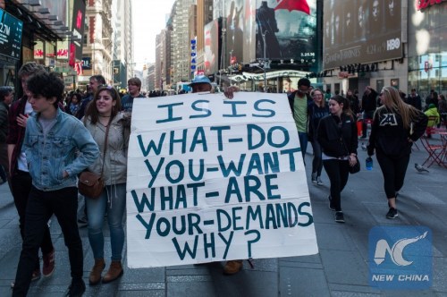 A man holds a sign as he protests ISIS at New York's Time Square, the United States, March 22, 2016. The Islamic State (IS) has claimed responsibility for Tuesday's terror attacks in Belgian capital of Brussels, which killed at least 34 people and injured more than 100. (Xinhua/Li Muzi)