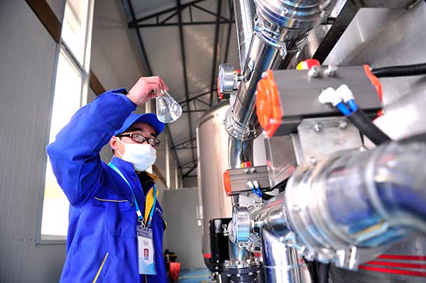 A staff member from a drinking water company tests water quality in Lhasa. Liu Kun / Xinhua