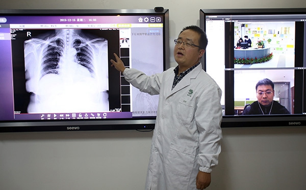 Doctor Zhao Cunzhong holds a consultation with other doctors as they look at a chest X-ray at Wuzhen Internet Hospital. (Photo by Zou Hong/China Daily)