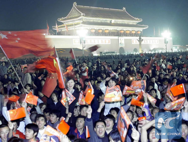 Chinese fans celebrate the Chinese team's qualification for the 2002 World Cup Finals on Oct 7, 2001 in Beijing. It was the only time that China made it to the World Cup. (Photo/Xinhua)