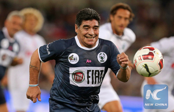 Former Argentinian soccer star Diego Maradona chases the ball in a charity match in Rome, Italy on Sept. 1, 2014. (Photo/Xinhua)