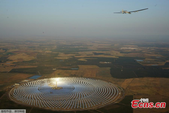 Solar Impulse2, a solar powered plane piloted by Swiss aviator Andre Boschberg, flies over the Gemasolar Thermosolar Plant in Seville, Spain after taking off towards Cairo, Egypt, from the San Pablo airport, July 11, 2016. (Photo/Agencies)