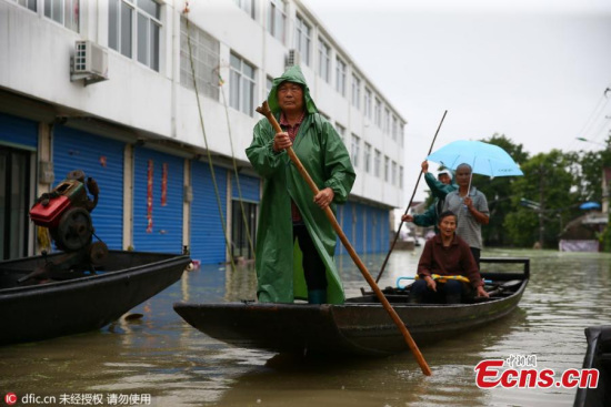 Residents use a boat for transportation in the flood-hit Langxi County of Xuancheng City, East Chinas Anhui Province, July 11, 2016. (Photo/IC)