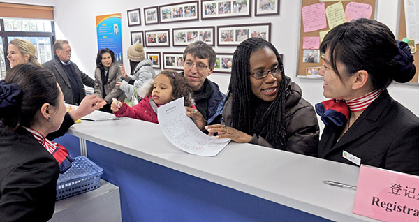 A family from the United States checks in at the Lianyang International Community service center in the Pudong New Area of Shanghai. (Photo/China Daily)