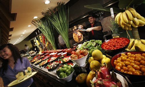 A cook prepares the buffet at Brazilian Churrascos. (Photo: Courtesy of Pei Pei)