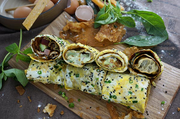 Beijing-style Peking duck jianbing with cucumber, sliced Peking duck, pickles and the sweet paste of flour. (Photo provided to China Daily)