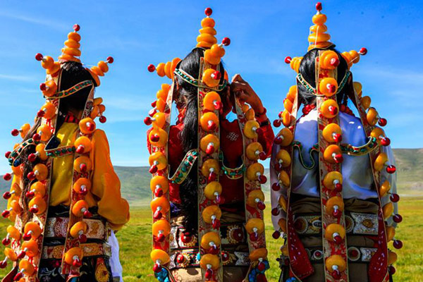 These round yellow accessories are made of rare amber. The number of accessories reflect the woman's family's economic condition. (Photo by Han Jiajun/chinadaily.com.cn)