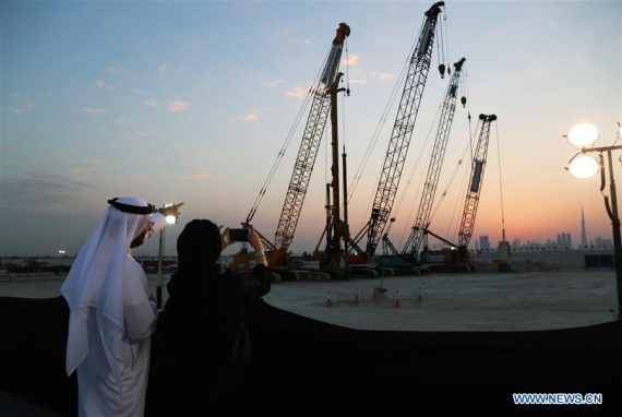 Guests take photos of the construction site of the one billion U.S. dollars project, the Tower at Dubai Creek Harbour, in Dubai, the United Arab Emirates, Oct. 10, 2016. (Photo: Xinhua/Li Zhen) 