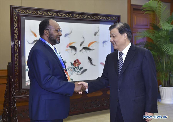 Liu Yunshan (R), a member of the Standing Committee of the Political Bureau of the Communist Party of China (CPC) Central Committee, meets with Charlot Salwai, president of the Reunification Movement for Change (RMC) and prime minister of Vanuatu, who attends The CPC in Dialogue with the World 2016 conference, in southwest China's Chongqing Municipality, Oct. 14, 2016. (Xinhua/Gao Jie)