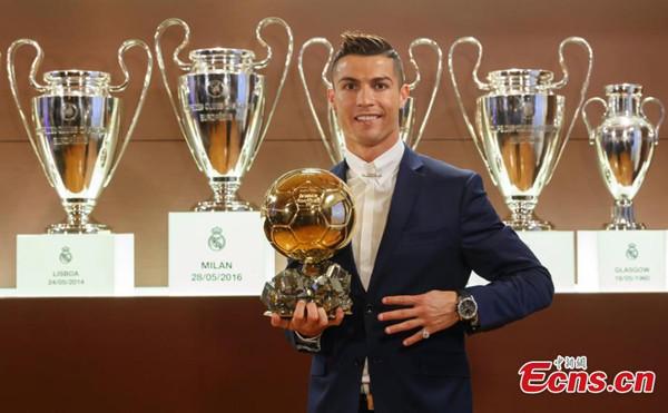 A handout picture provided by France Football on December 12, 2016 of Real Madrid's Portuguese striker Cristiano Ronaldo posing with the Ballon d'Or 2016 trophy at Bernabeu stadium in Madrid, Spain, December 8, 2016.(Photo/CFP)