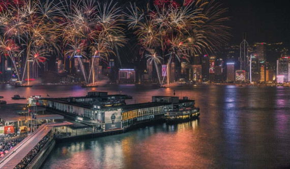 Fireworks light up the night sky at Victoria Harbor in Hong Kong. (Photo by Mo Hanbing)