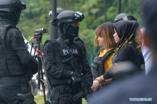 Vietnamese national Doan Thi Huong (2nd R, in yellow) leaves the Sepang court as she is escorted with Malaysia special armed forces in Sepang, Malaysia, on March 1, 2017.  (Xinhua/Chong Voon Chung)