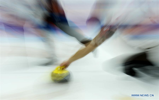 Raphael Maerki of Switzerland delivers a shot during the China Qinghai international curling competition between the U.S. and Switzerland in Xining, Qinghai Province, Dec. 13, 2016. (Photo/Xinhua)