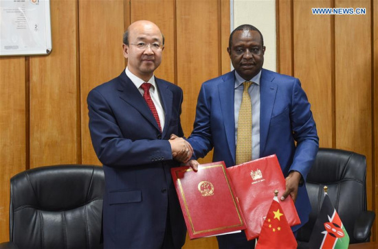 Chinese Ambassador to Kenya Liu Xianfa (L) shakes hands with Kenya's Treasury Cabinet Secretary Henry Rotich during a donation ceremony in Nairobi, capital of Kenya, March 27, 2017. (Xinhua/Li Baishun)