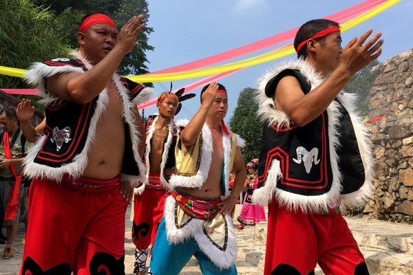 Members of the Qiang ethnic group perform a traditional dance in Qishuping village, Guizhou province. (Photo by Long Chao/China Daily)