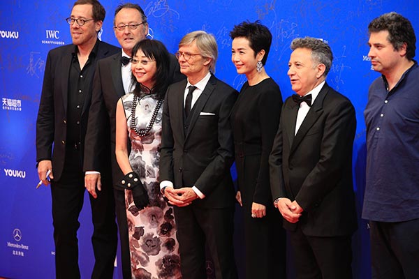 A seven-member international jury, including Danish cinematic master Bille August (center), Hong Kong director Mabel Cheung (third left) and actress Jiang Wenli, at the opening of the film festival. (Photo by Jiang Dong/China Daily)