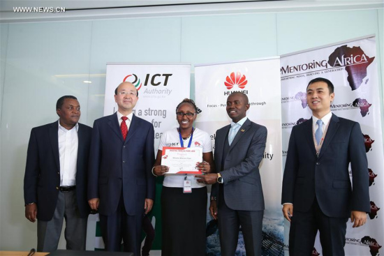 Kenyan Cabinet Secretary for ICT Joe Mucheru (2nd R) and Chinese Ambassador to Kenya Liu Xianfa (2nd L) give a certificate to a trainee at the graduation ceremony of Huawei digital skills development program in Nairobi, capital of Kenya, on April 26, 2017. (Xinhua/Pan Siwei)