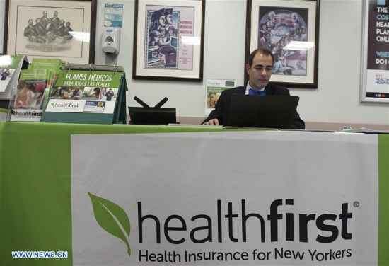 A staff member works at a health insurance counter at a hospital in New York, the United States on May 3, 2017. (Xinhua/Wang Ying)