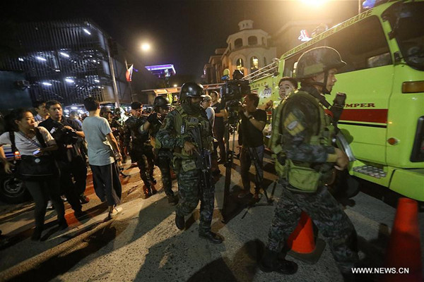 Security forces secure the surroundings of Resorts World Manila after an attack in Pasay City, the Philippines, on June 2, 2017. Unidentified gunmen attacked Resorts World Manila in Pasay City around early hours of Friday, causing injuries among the hotel and casino guests who scampered after the shooting. (Xinhua/Stringer)