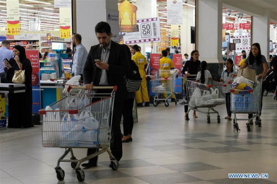 People buy food at a supermarket in Doha, capital of Qatar, on June 6, 2017. Bahrain, the United Arab Emirates and Yemen joined Saudi Arabia and Egypt in severing relations with gas-rich Qatar, with Riyadh accusing Doha of supporting groups, including some backed by Iran. (Xinhua/Nikku)