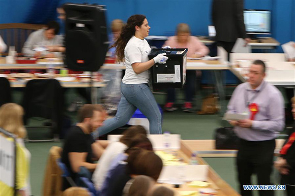 Staff members count votes at a polling station in Sunderland, Britain on June 8, 2017.  (Xinhua)