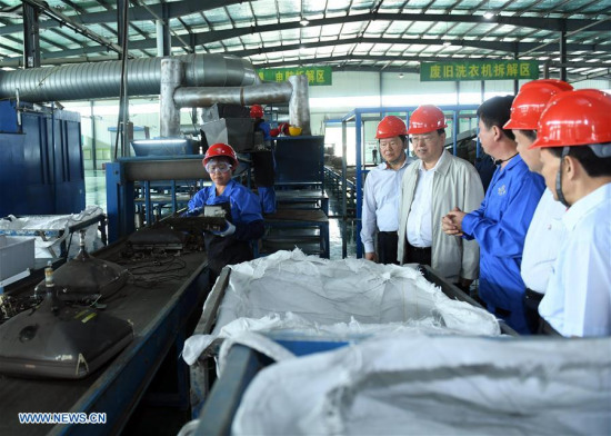 Zhang Dejiang, chairman of the Standing Committee of the National People's Congress, checks the work of recycling and reuse of solid waste at an industrial park in northwest China's Shaanxi Province, June 7, 2017. (Xinhua/Zhang Duo)