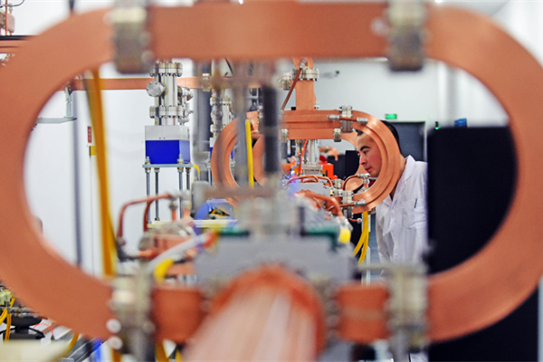 A researcher from the Chinese Academy of Sciences examines the Dalian Coherent Light Source. (Photo/Xinhua)