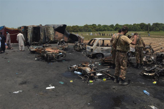 Pakistani soldiers examine the oil tanker accident site in eastern Pakistan's Bawahalpur, on June 25, 2017. (Xinhua/Stringer)