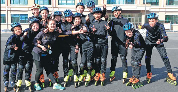 Zhang (fifth from left) and 13 members of the Special Olympics short-track speedskating team in Qitaihe.