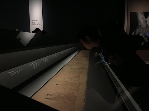 A visitor examines <i>The Admonitions Scroll</i> at the British Museum. (Photo/Courtesy of British Museum)