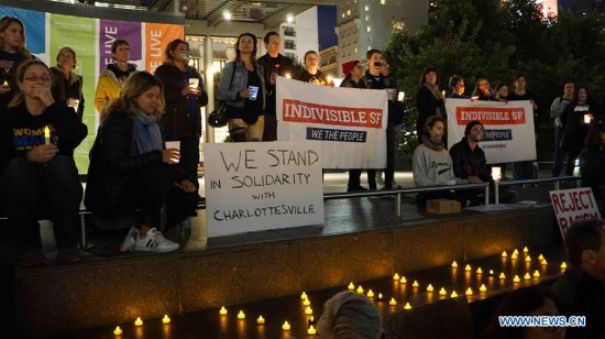 People take part in a candle light vigil in downtown San Francisco, the United States, on August 12, 2017. (Xinhua/Xu Yong)