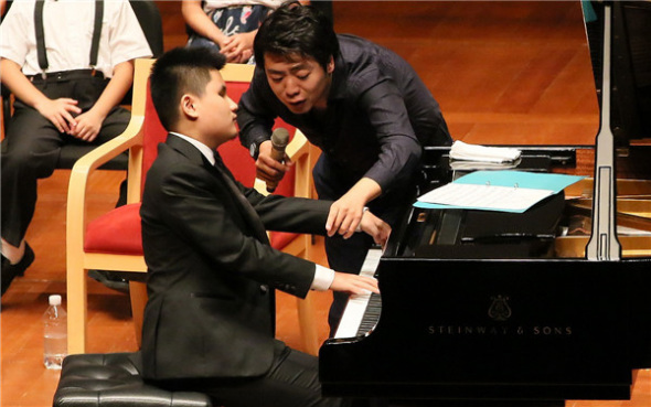 Lang Lang gives instructions to young musicians at an open master class on Monday at the National Center for the Performing Arts in Beijing. Lang Lang, pianist.