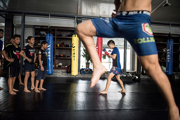 Youngsters practice mixed martial arts at the Enbo MMA Club in June in Chengdu, Sichuan province.(Fred Dufour/For China Daily)