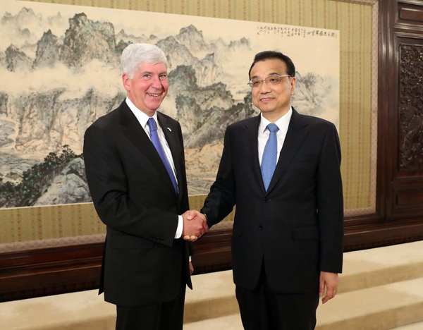 Premier Li Keqiang meets Michigan Governor Rick Snyder in Zhongnanhai, the central leadership's compound, in Beijing on Tuesday. They discussed a range of subjects, from trade to investment and employment. (Photo/Xinhua)