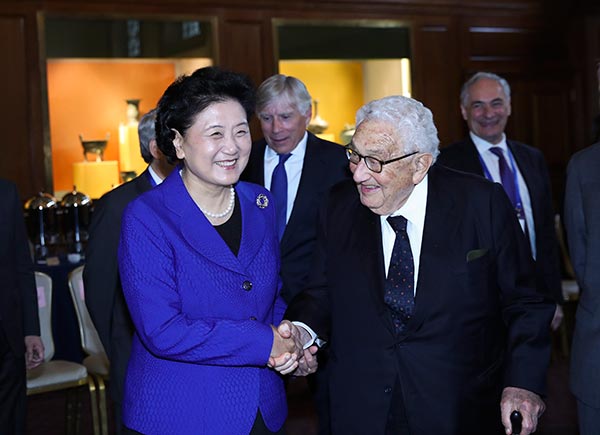 Vice-Premier Liu Yandong shakes hands with former U.S. secretary of state Henry Kissinger before a forum where they both spoke at Columbia University in New York on Tuesday. WANG YING/XINHUA